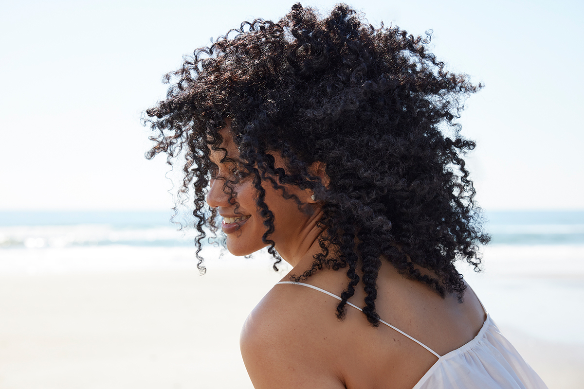 smiling woman on beach laughing